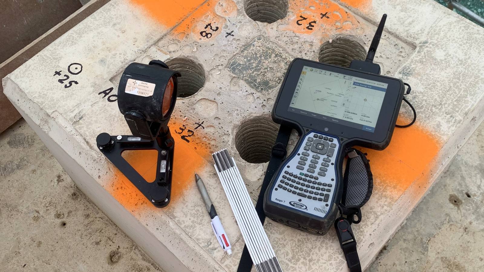 Pile cap bolt group marked up with mini prism and Ranger 7 — holding-down set-out